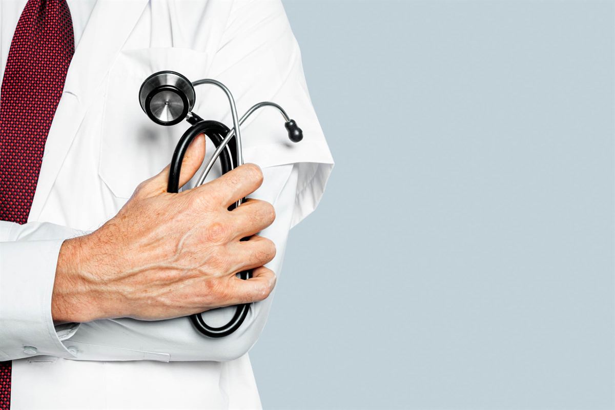 Doctor holding a stethoscope in a clinic setting